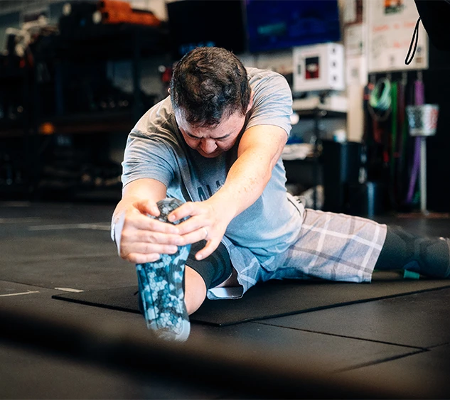 man stretching at All Kine Community and Fitness